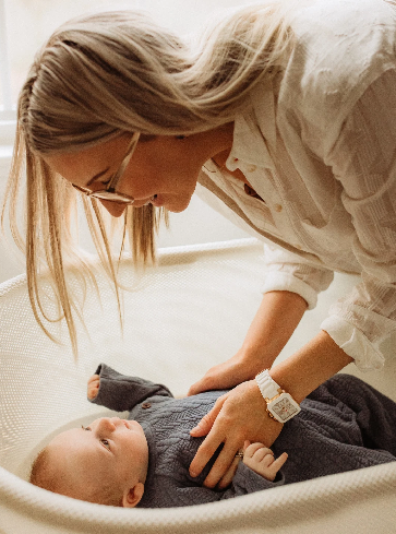 mom laying down baby Mother checking on their child